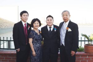 Family portrait on Aiden and Mary’s wedding day (L-R) brother Stephen, Marsha, Aiden, and father Tad Aizumi. Long Beach, CA, 2013. Photo courtesy of Marsha Aizumi.