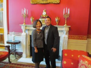 Marsha and Aiden Azumi smile in formal outfits and hug at the White House Red Room, during a meeting with President Obama in Washington D.C., 2012. Photo courtesy of Marsha Aizumi.