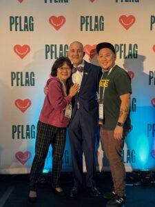 PFLAG National Convention event photo of (L-R) Marsha Aizumi, PFLAG National CEO Brian Bond, and Aiden Azumi in Washington, D.C., 2023. Photo courtesy of Marsha Aizumi.