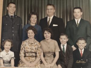 Wehrle family photo with Tom, Helen (mother), Bob (Monica’s dad), Peggy, Monica, Sue, Jim, and Joe. In Fort Wayne, Indiana, 1962. Photo Courtesy of Harriet Miller and Monica Wehrle.