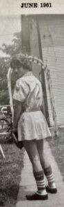 Grayscale photo of Monica as a girl/young teen in her baseball/softball uniform. Fort Wayne, Indiana, 1961. Photo Courtesy of Harriet Miller and Monica Wehrle.