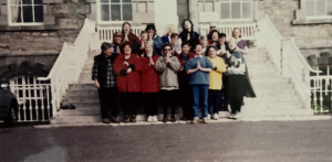 Harriet Miller and Monica Wehrle with an Ireland Sounds and Furies Travel Group in 
front of some steps. Ireland, 1999. Photo Courtesy of Harriet Miller and Monica Wehrle.