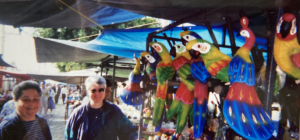 Harriet Miller and Monica Wehrle in a colorful outdoor marketplace in Guadalajara, Mexico, 2001. Photo Courtesy of Harriet Miller and Monica Wehrle.