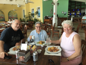 L-R, Cousin Jim, Harriet Miller, and Monica Wehrle at a colorful restaurant in Cancun, 
Mexico, 2018. Photo Courtesy of Harriet Miller and Monica Wehrle.