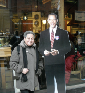 Harriet Miller at President Obama’s Inauguration in Washington, D.C. smiling next to a life-size Obama cut-out, 2009. Photo Courtesy of Harriet Miller and Monica Wehrle.