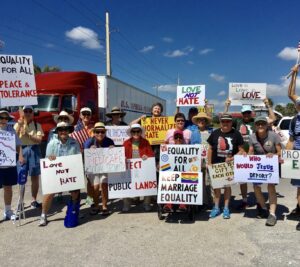 Harriet Miller, Monica Wehrle among a crowd of fellow protesters at a Florida Peace 
Rally. In Fort Myers, Florida, 2019. Photo Courtesy of Harriet Miller and Monica Wehrle.
