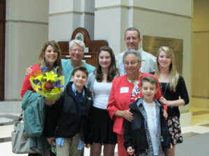 Harriet Miller and Monica Wehrle smile with three generations their Ohrn-family  outside a building’s front steps. In Indianapolis, Indiana, 2011. Photo Courtesy of Harriet Miller and Monica Wehrle.