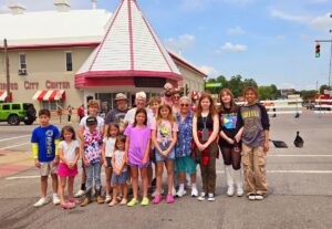 Harriet Miller and Monica Wehrle with three generations of family friends, including the Luke kids outside of a circus tent. In Peru, Indiana, 2024. Photo Courtesy of Harriet Miller and Monica Wehrle.