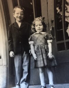 Grayscale photo of Monica Wehrle (R) with brother Bob (L) in Fort Wayne, Indiana, 1952. Photo Courtesy of Harriet Miller and Monica Wehrle.